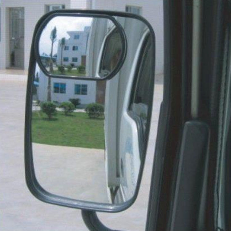 Black truck blind spot mirror mounted on vehicle side, showing reflected view