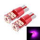 Pair of T10 LED bulbs with purple light glow in front inset