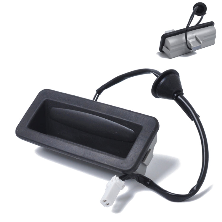 Black tailgate release switch with wiring harness and white connector plug
