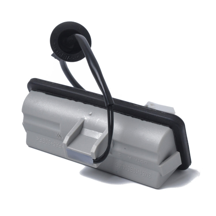 Silver and black tailgate release switch actuator with black cable loop