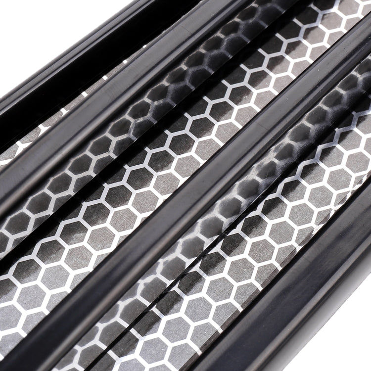 Close-up of black honeycomb grille-look decorative sticker with hex pattern