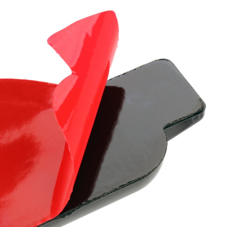 Close-up of red car decorative sticker edge on black backing