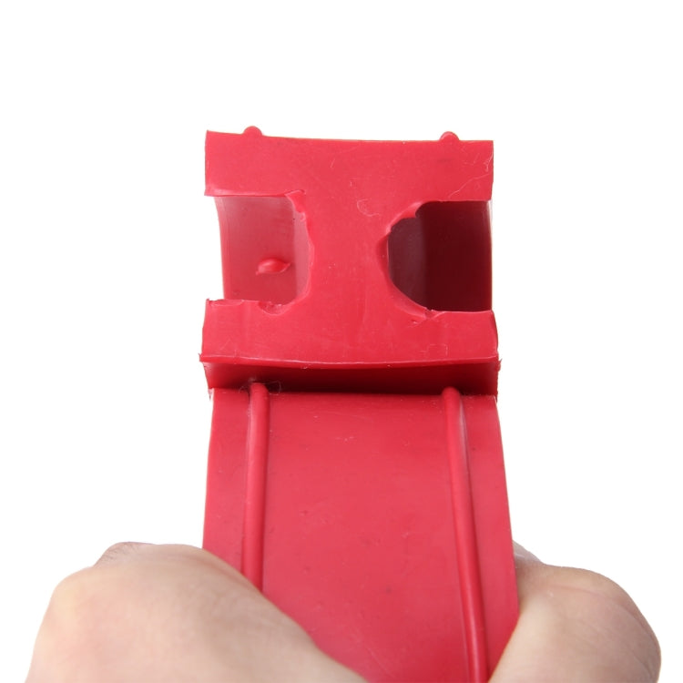Red D-type shock absorber spring bumper buffer with cutouts, held in hand