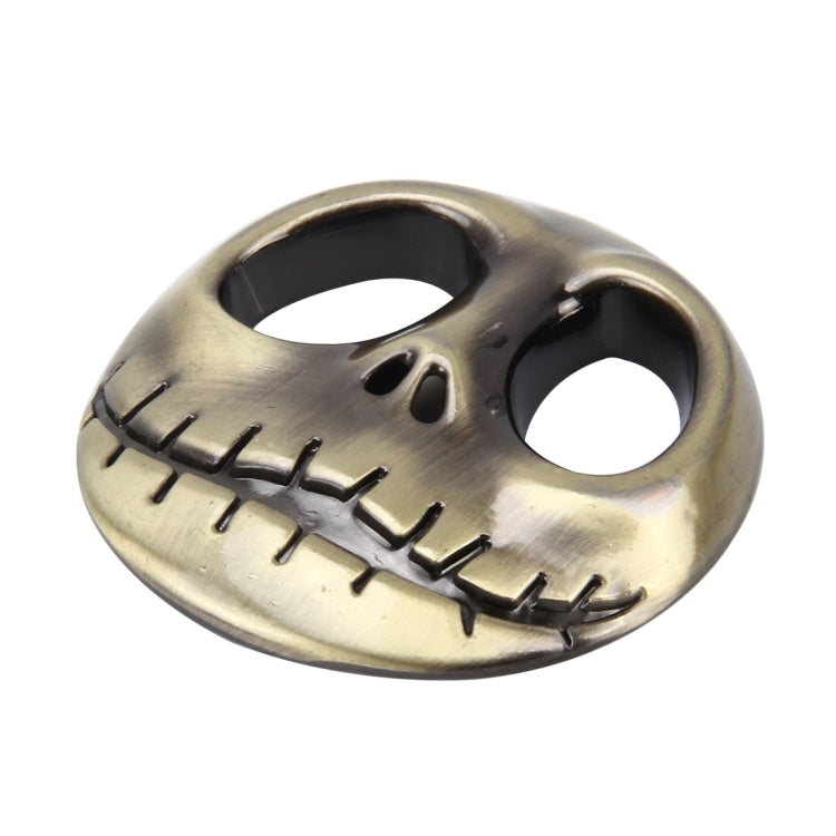 3D metal skull auto sticker with black cutout eyes and engraved teeth, gold finish