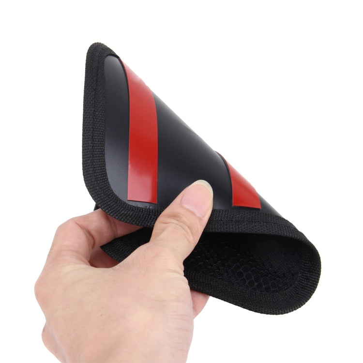 Black car seat storage bag with red accent stripe on fold