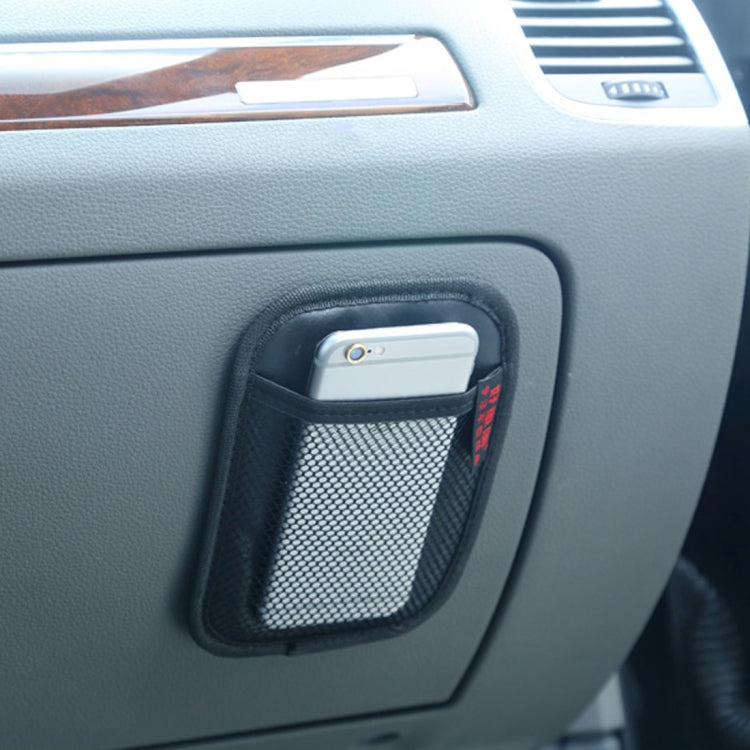 Black car seat storage bag mounted on car panel with mesh pocket