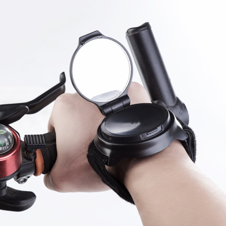 Wrist strap rear view bike mirror on a hand with round convex mirror surface