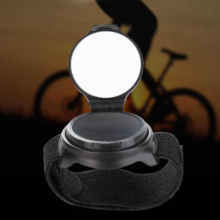 Circular bicycle rear view wrist mirror with dark strap, mirror cover open