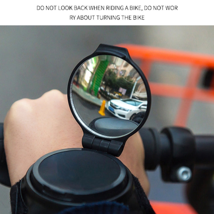 Round rear view bike mirror showing street scene from bicycle wrist mount