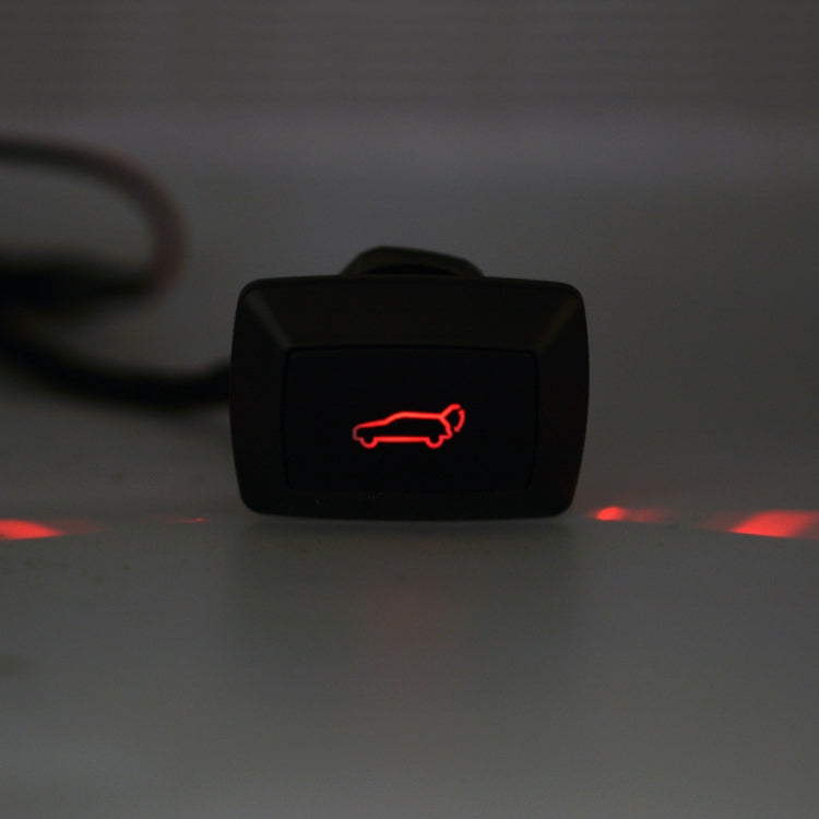 Car trunk release LED switch with glowing red car icon on black face
