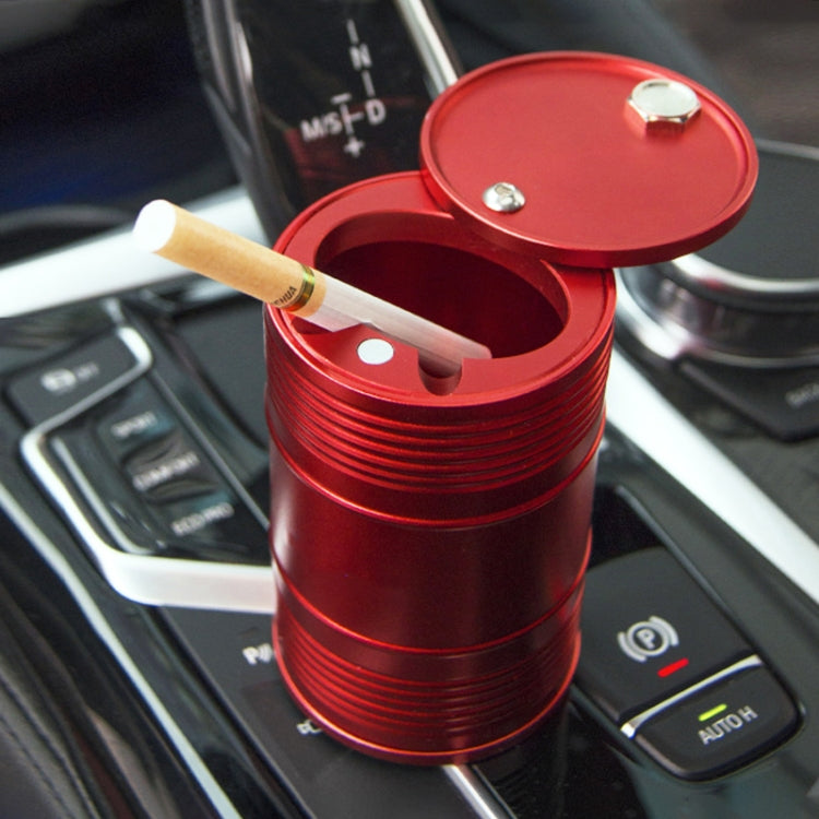 Red metal portable car trash bin/ashtray with open rotating lid and cigarette inside