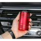 Red metal portable car trash bin/ashtray held in hand with rotating lid
