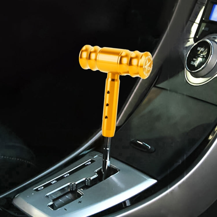 Universal car gear shift knob with T-shaped handle, gold finish, installed in car interior