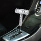 Silver T-shaped car gear shift knob with threaded metal head and mounting stem
