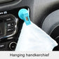 Blue suction cup clip holding a hanging tissue on car dashboard