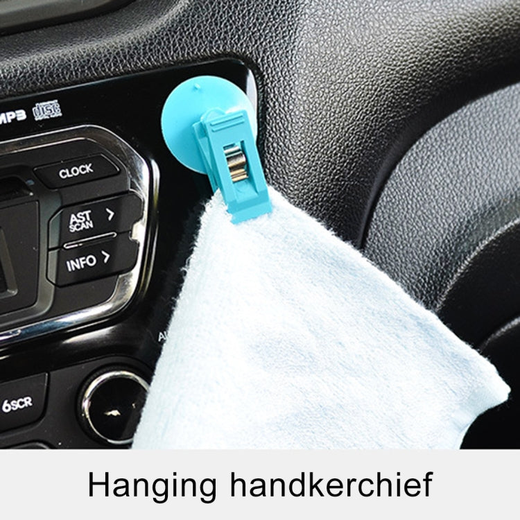 Blue suction cup clip holding a hanging tissue on car dashboard