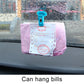 Blue suction cup clip holding bills on car dashboard