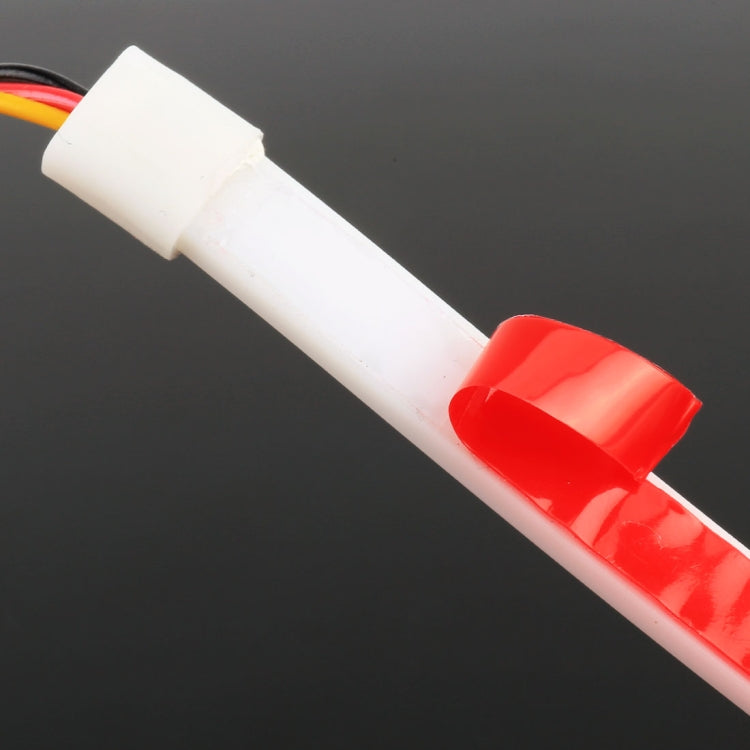End view of slim LED light strip with red cover and white connector, wire leads