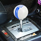 White resin gear shift knob with blue stripe bands and 5-speed number markings