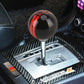 Black ball-style gear shift knob with red stripe and 246 marking