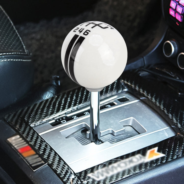 White ball gear shift knob with black 246 markings and cross stripes
