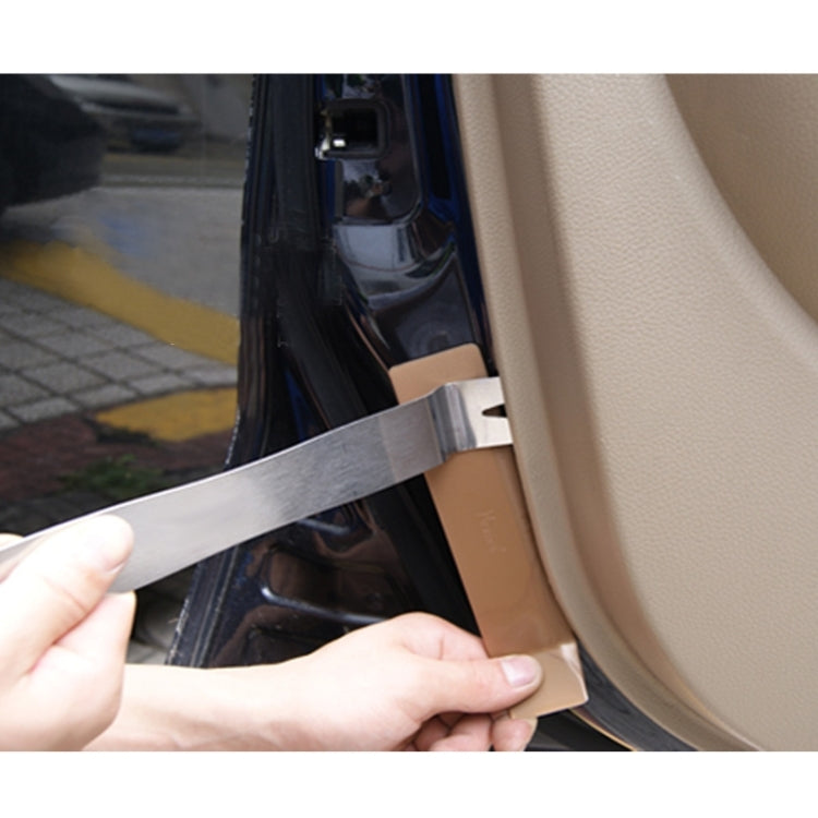 Metal wrecking bar prying at an exterior panel edge