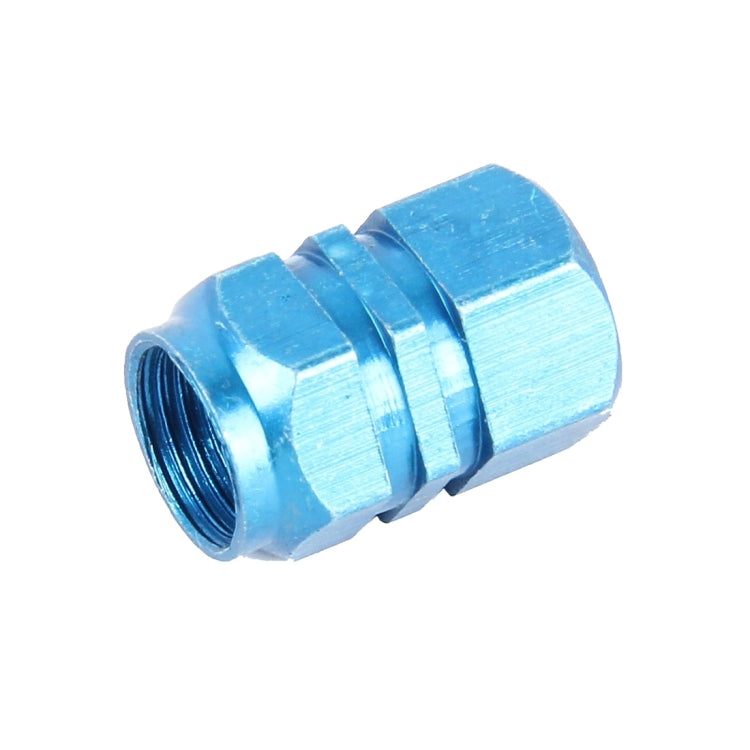 Blue metal plated hexagon tire valve stem cap, angled side view, ribbed texture
