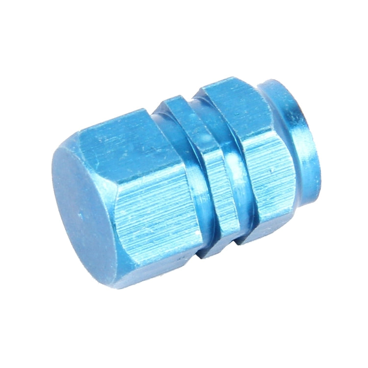 Blue metal plated hexagon tire valve stem cap, front close-up, ridged outer surface