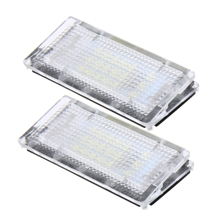 Two clear LED license plate lights with textured lens covers, side-by-side