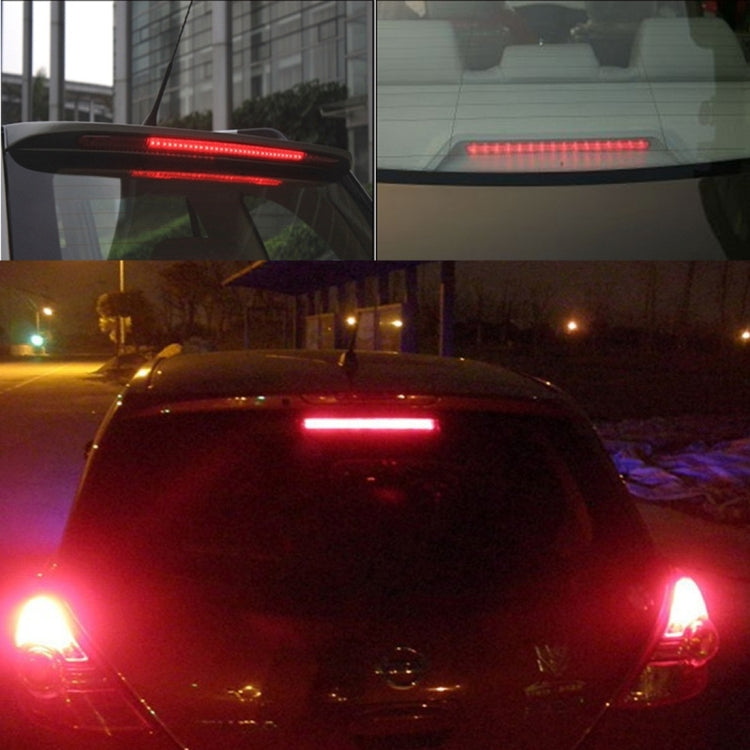 Red LED third brake light strip lit on the rear window of a car
