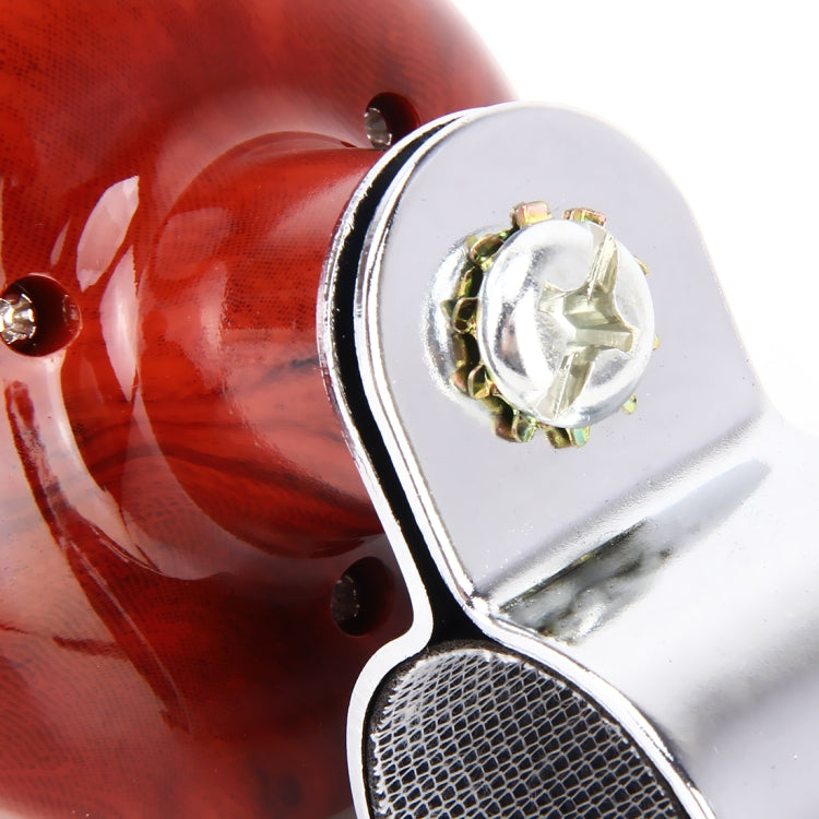 Close-up of red spinner knob and silver bracket with mesh grip