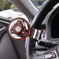 Red wheel spinner knob attached to car steering wheel with chrome mounting bracket