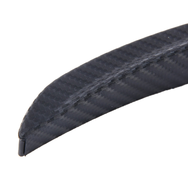 Close-up of black textured carbon-fiber style rubber fender guard strip