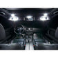 Car interior showing lit LED vanity mirror lights near the roof