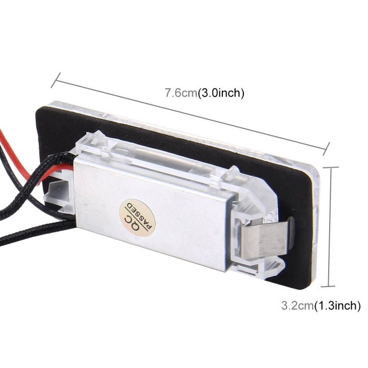 License plate light module with clear plastic housing and visible size markings on mount