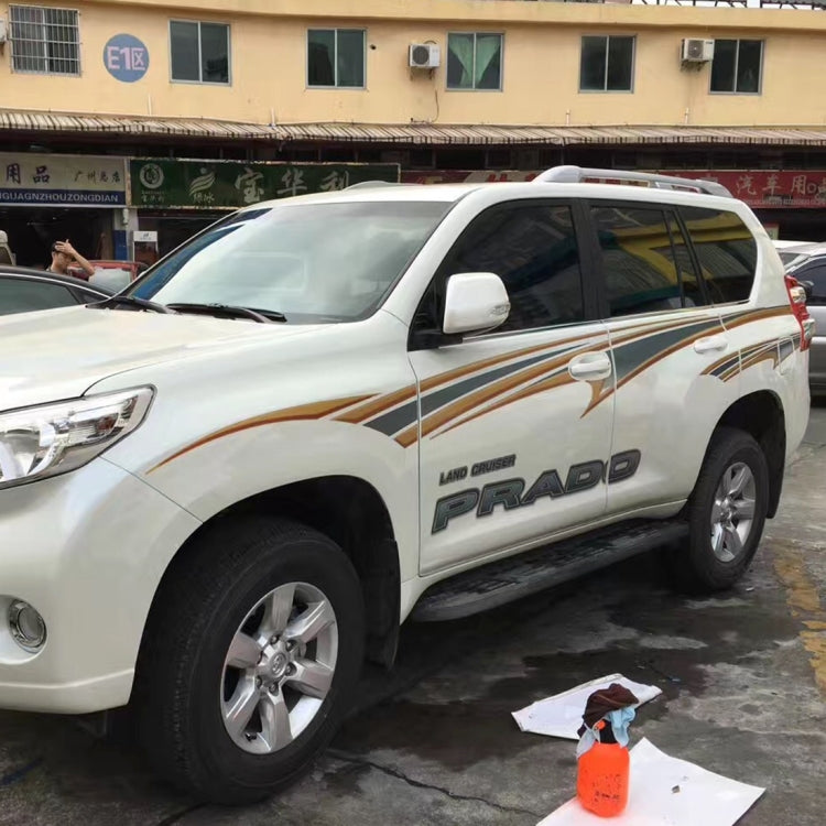 Applied gold-and-black body strip decals on white SUV door and fender