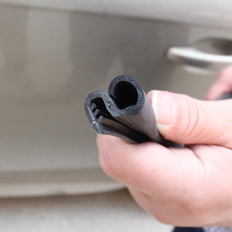 Black rubber seal strip end with mounting groove, held by hand for install