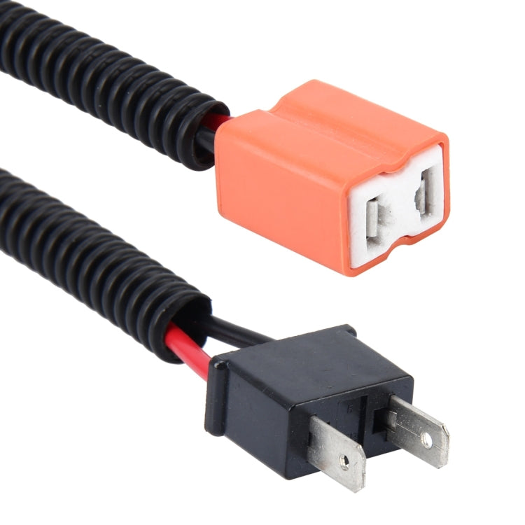 Close-up of H7 HID headlight conversion cable connectors: orange plug and black socket