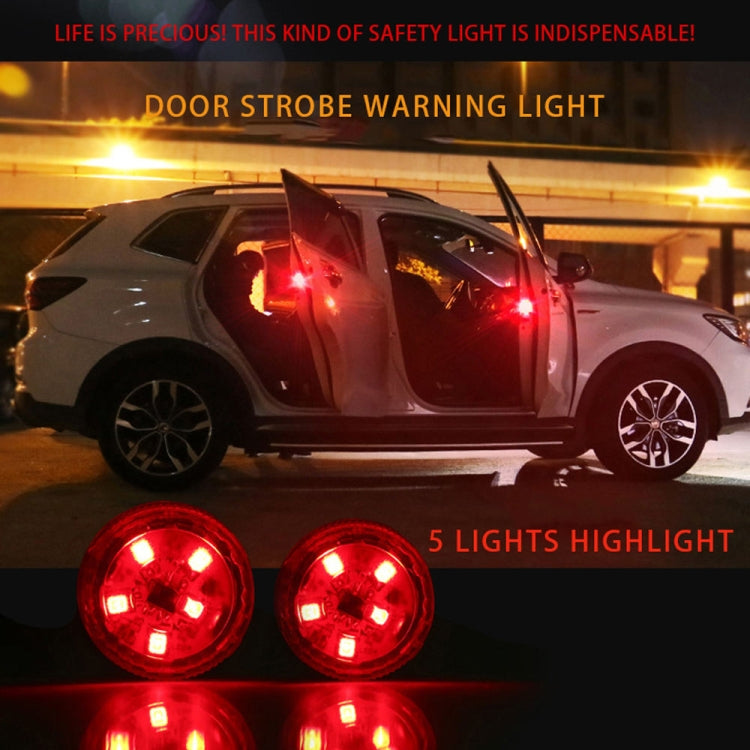 Two red strobe warning lights mounted near a car door edge, glowing