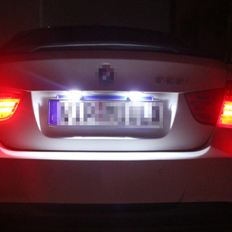 LED license plate lights on car rear, bright white illumination over license plate area