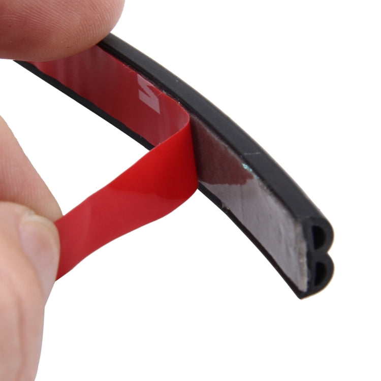 Close-up of black B-shape rubber seal strip with red insert and open channel