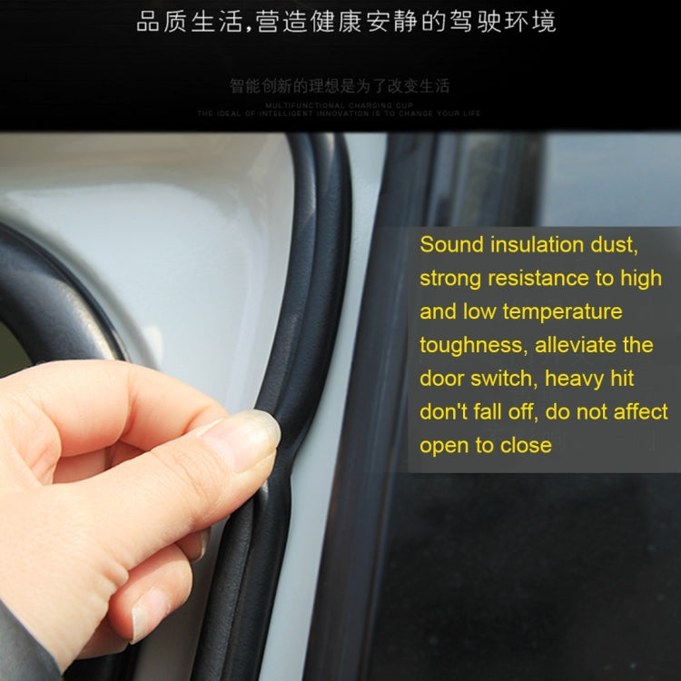 Hand pressing black rubber door seal strip into place along door gap