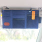 Dark blue car sun visor organizer mounted on car visor with sunglass pocket