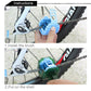 Hand fitting blue bristle brush onto green bicycle chain cleaning tool