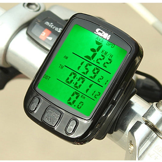 Black wired bicycle computer with green LCD showing speed and trip data