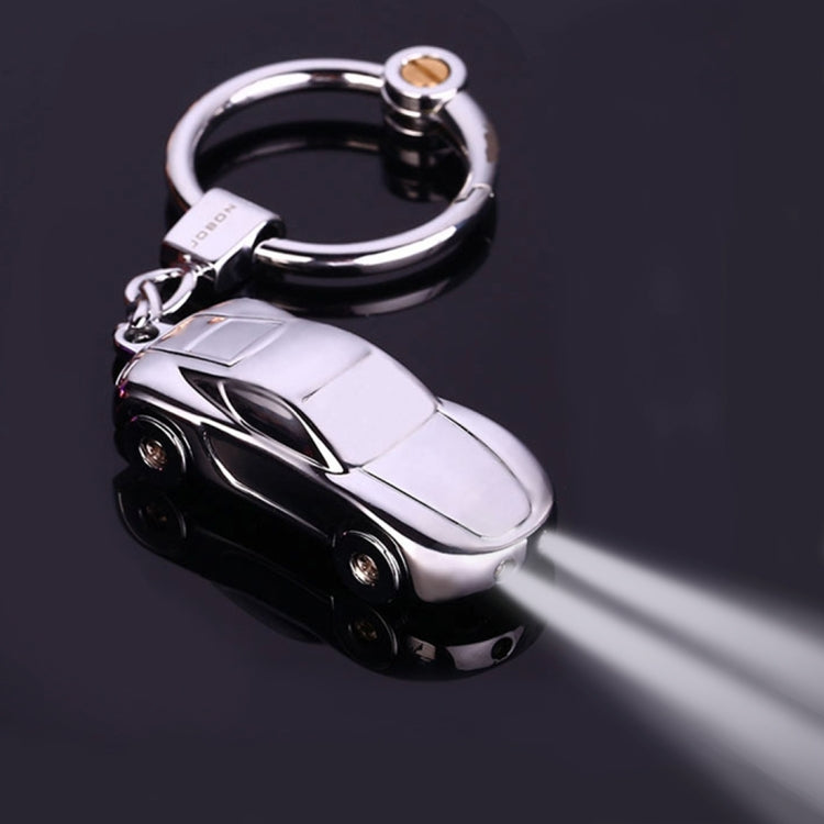 Metal car shape keychain holder with circular ring and miniature car charm, dark and silver.