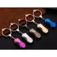 Set of metal car shape keychain holders with different colored miniature car charms and rings.