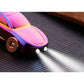 Close-up of rainbow metal car keychain charm with wheels and circular ring attachment.