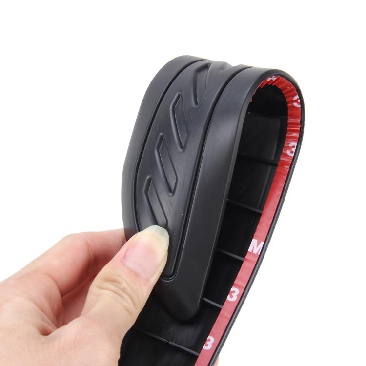 Hand-held black rubber bumper guard strip with curved edge and inner channel