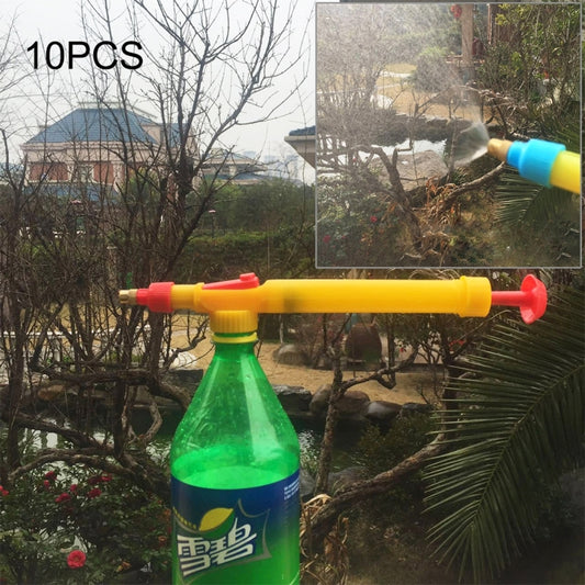 Manual bottle sprayer with yellow handle and green bottle, emitting a fine spray stream.